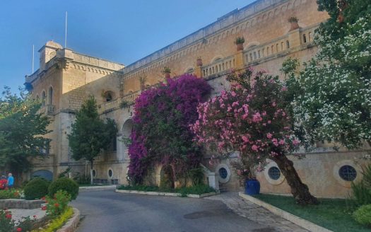 Ratisbonne Monastery in Rehavia, Jerusalem – stone facade with blooming bougainvillea and oleander