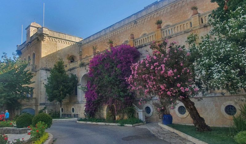 Ratisbonne Monastery in Rehavia, Jerusalem – stone facade with blooming bougainvillea and oleander